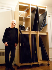 Art Storage System for storing photographs.  Self-portrait photo by William Loeb showing his large format photo prints stored in his Art Storage System by Art Boards™.