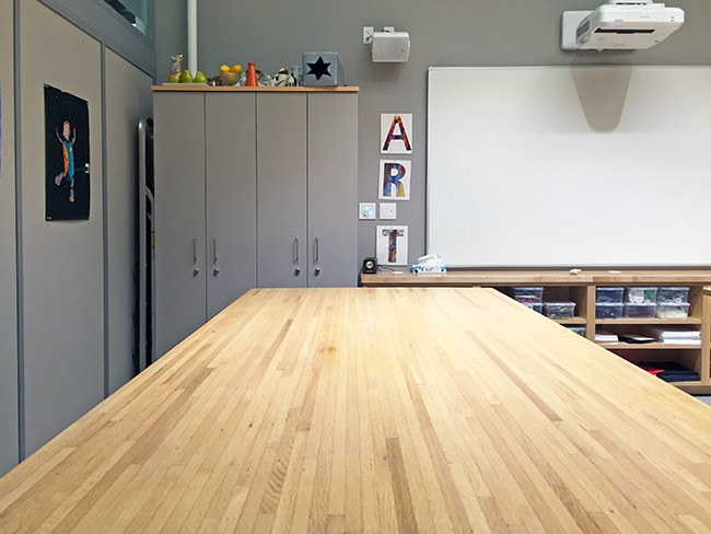 Art School Art Work Table on wheels has a butcher block counter that is 48 x 96 with art and art supply storage sabinets below.